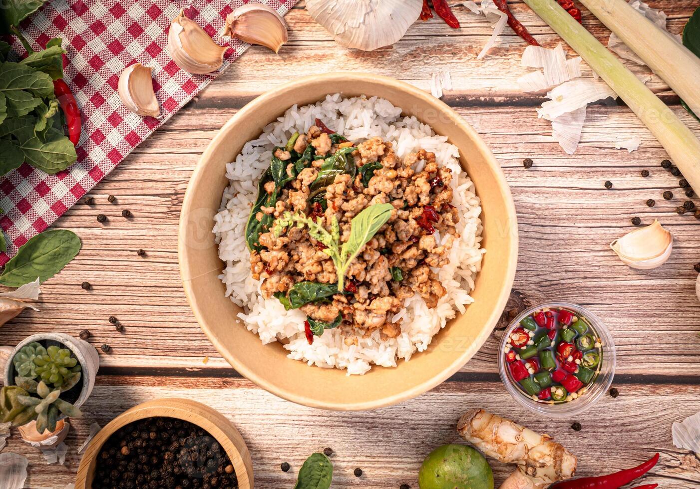 The Pork with basil in paper Bowl for Thai food concept. photo