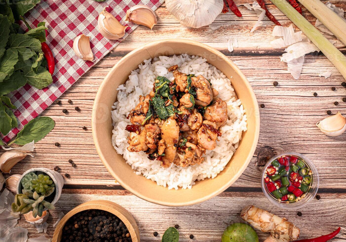 The Chicken with basil in paper Bowl for Thai food concept. photo