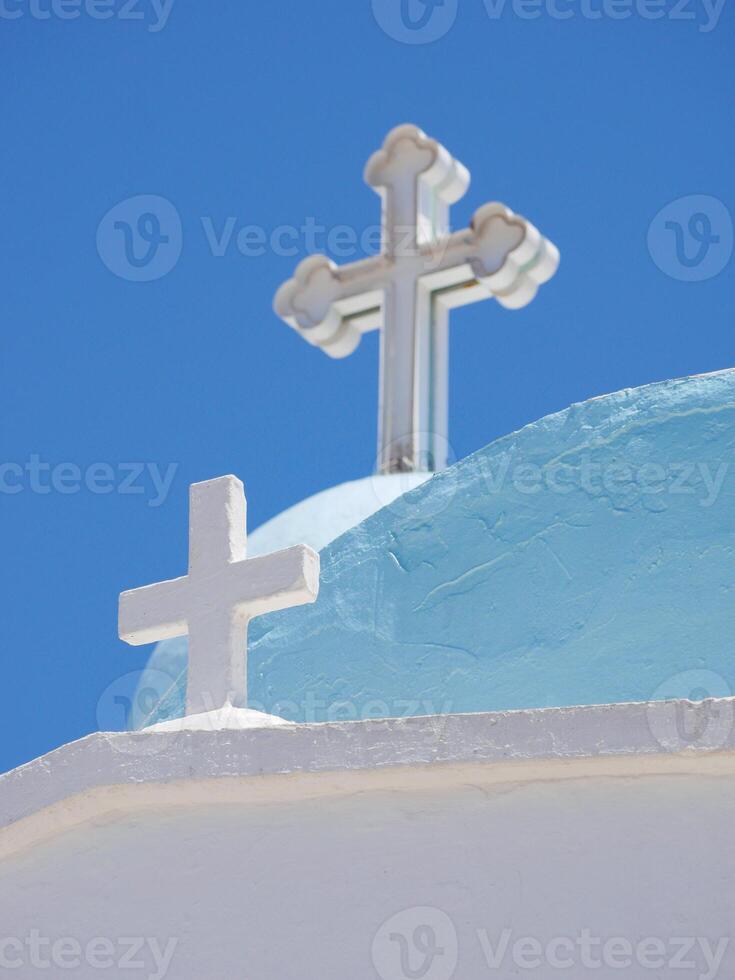 Traditional Greek Orthodox Church at the Lycabettus hill in Athens. Blue dome and white crosses close-up at the background of the sky photo