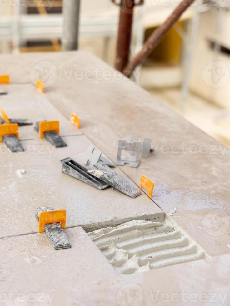 Laying ceramic tile on the floor. Home renovation or building new house photo
