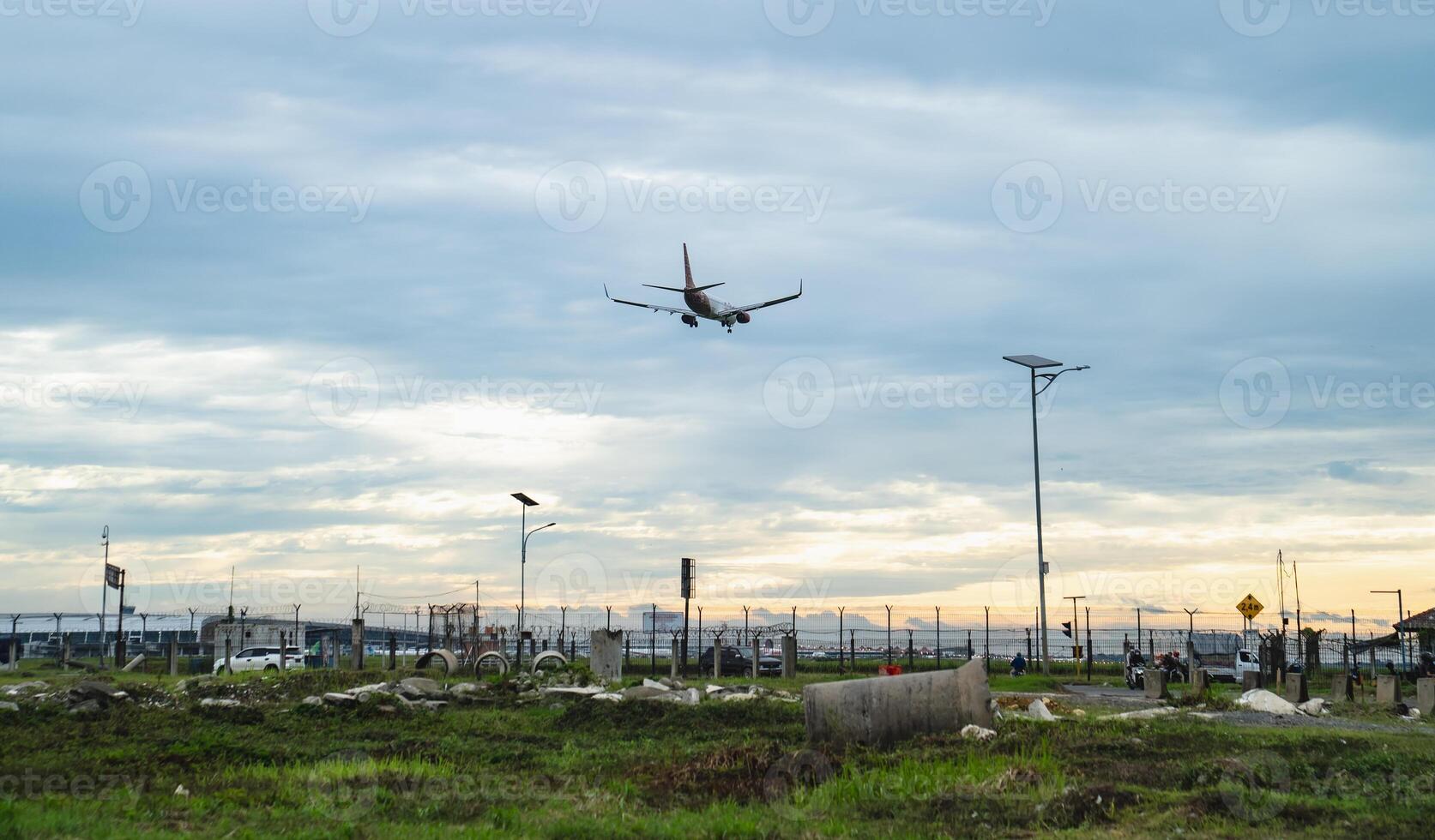 Airplane approaching for landing at the airport during sunset photo