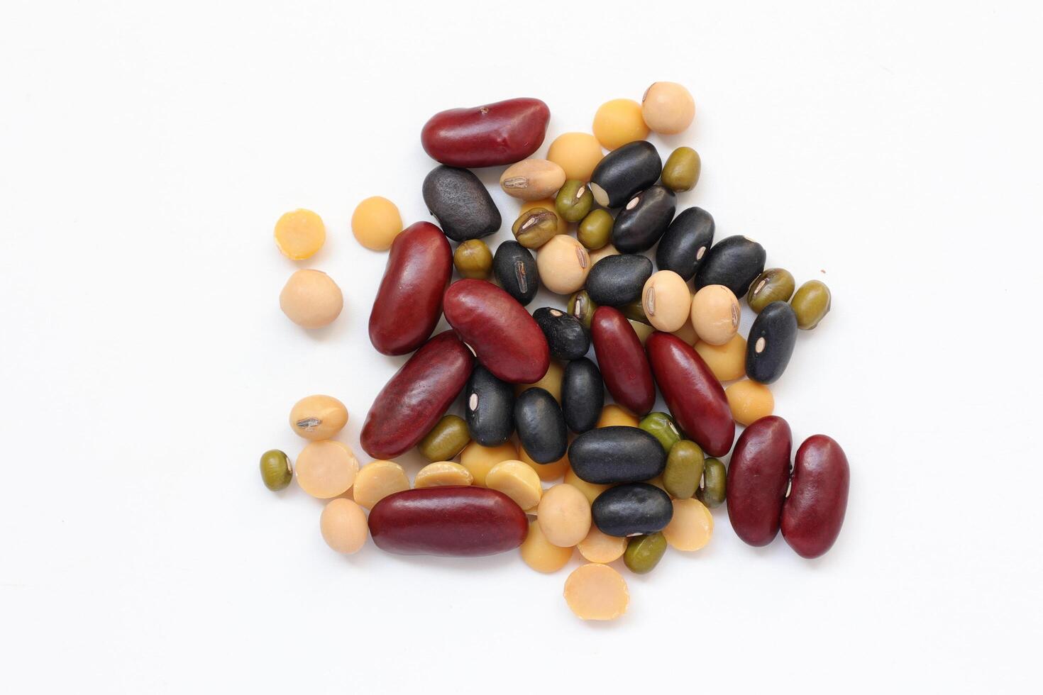 a pile of beans and other legumes on a white background photo
