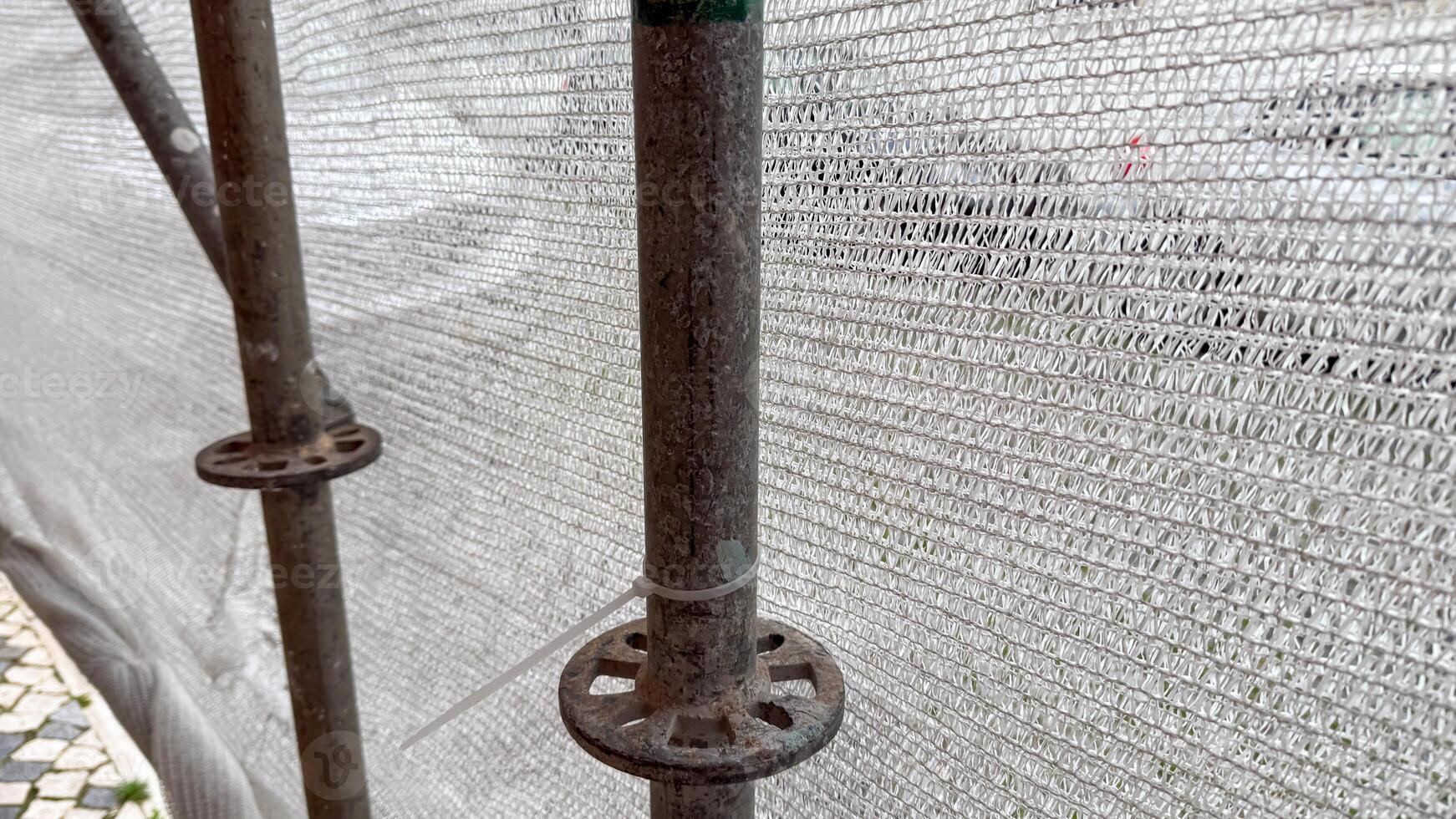 Rust kissed scaffolding pole, whispers of urban renewal, echoes of labor, reminiscent of Labor Day and Silent Work Day photo