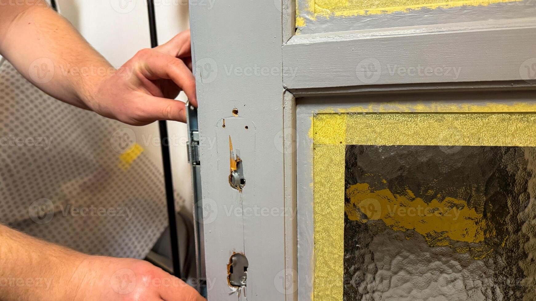 Craftsmans hands attend to aging door, rustic DIY restoration, embodying nostalgic charm, vital home repair, Fix a Leak Week photo