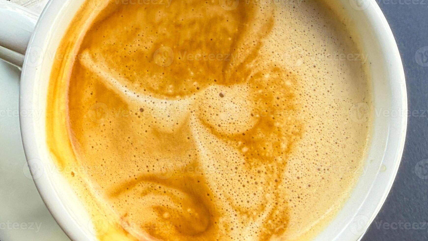 Creamy latte art swirls chaotically, embodying autumns cozy whispers, perfect for International Coffee Day and Hygge celebrations photo