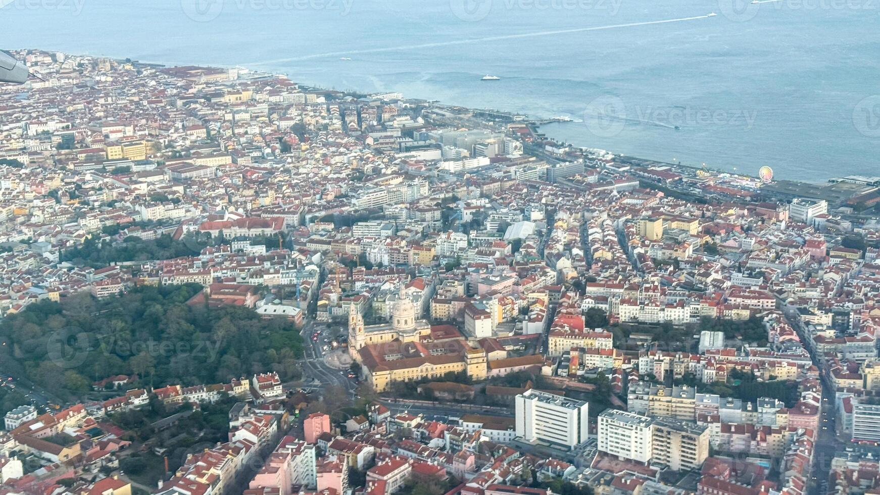 Aerial view of coastal cityscape, colorful mosaic of colonial rooftops, whispers of Carnival, sunlit Mediterranean escape, vibrant urban tapestry photo