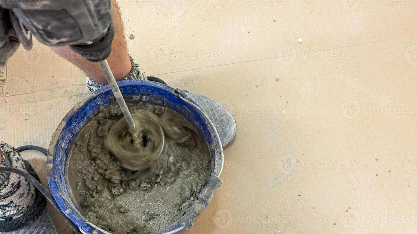 Mixing cement in swirling dance of gritty artistry, Earth Day construction, tactile craftsmanship, urban renovation celebration photo