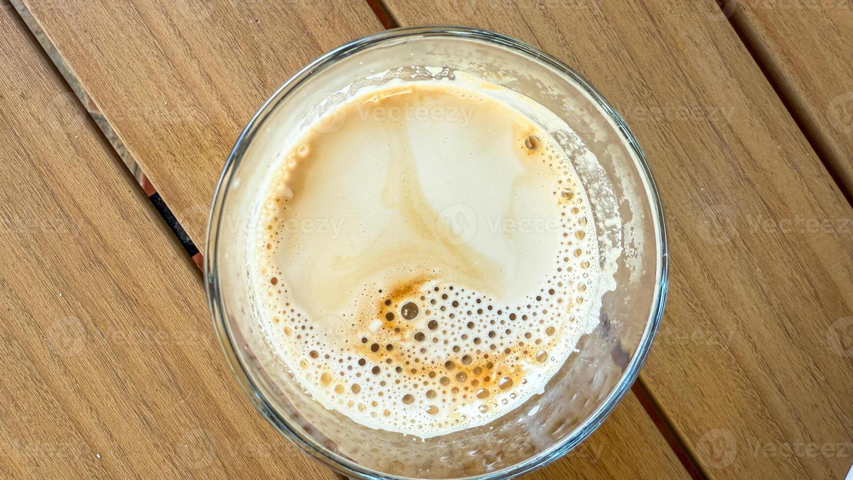 Effervescent latte topography swirls in a glass, invoking National Coffee Day zen, echoing hygge and artisan espresso craftsmanship photo
