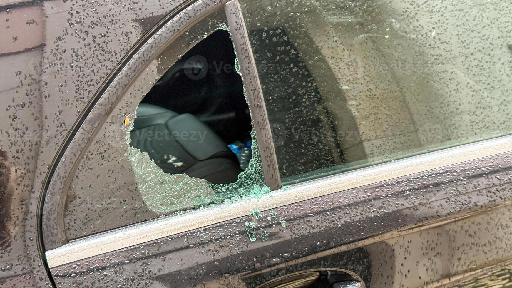 Raindrops scatter on a shattered car window, urban mystery lingering, capturing noir essence, akin to Bonfire Night intrigue photo