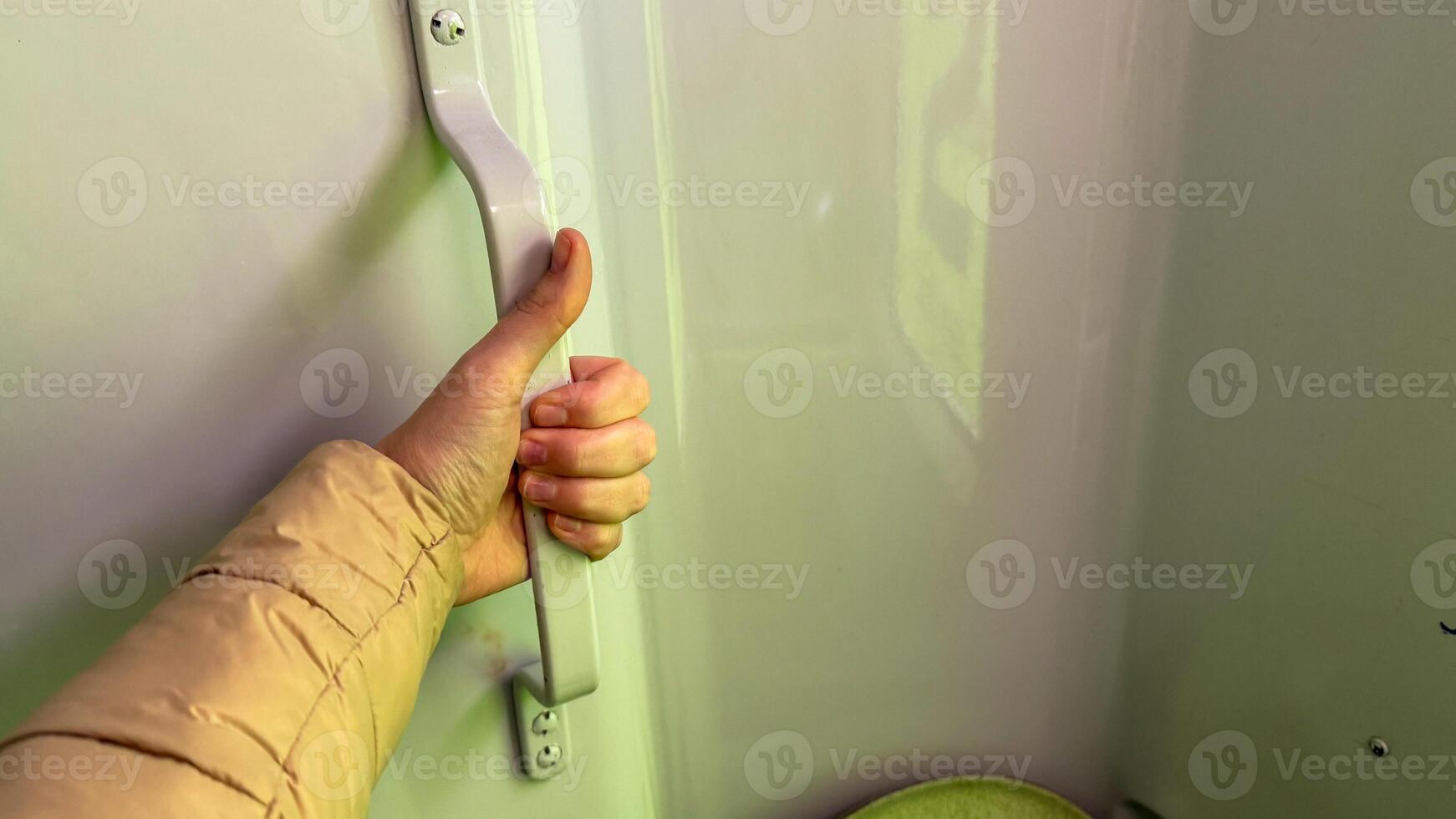 A hand gripping an enigmatic train door handle, suggesting a journey into worlds unknown, perfect for National Train Day photo