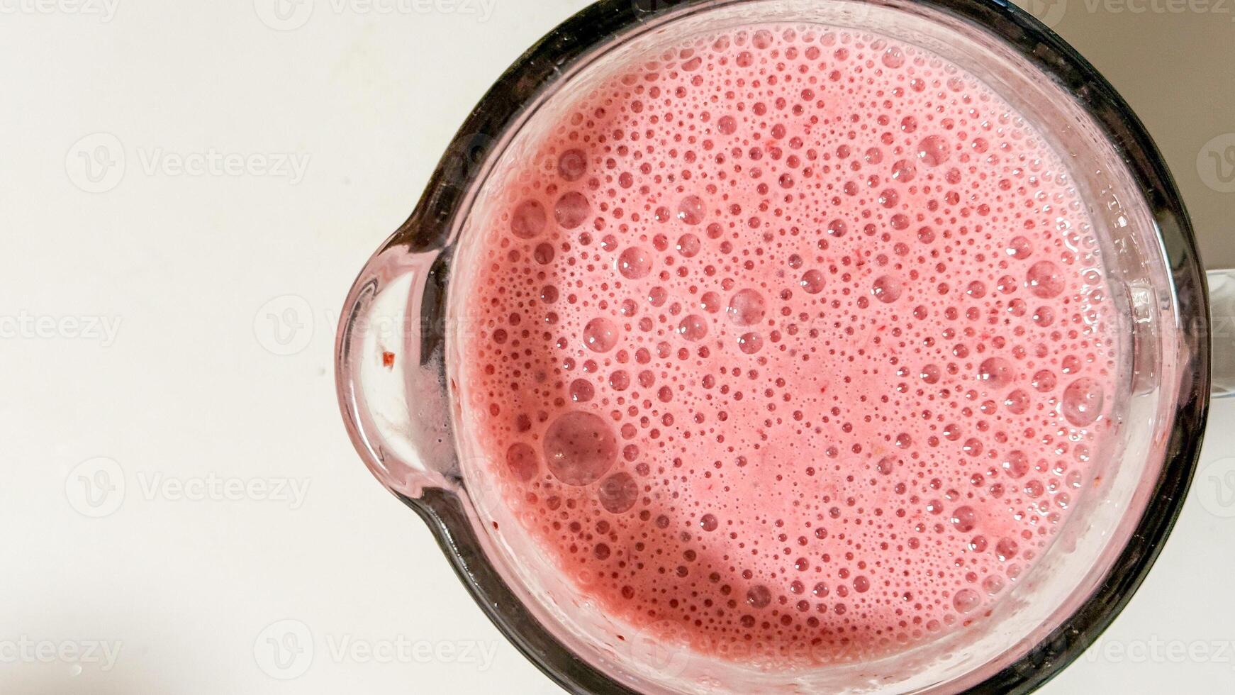 Foamy strawberry nectar in a glass pitcher, reminiscent of summer solstice indulgence, wellness elixir, and whimsical pink serenade photo