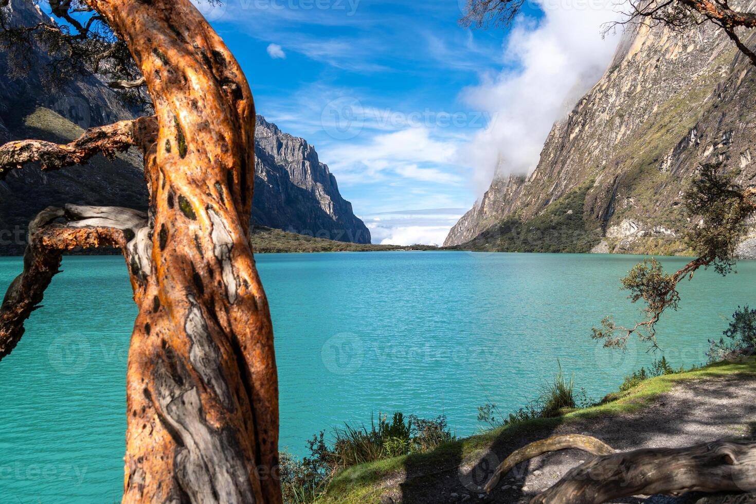 Turquoise lake surrounded by mountains on the Laguna 69 trek, Peru photo