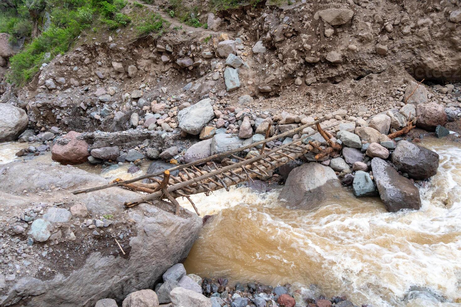 Old bridge crossing the river in Colca Canyon, Peru photo