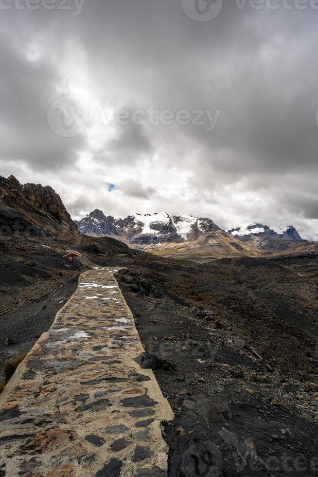 Stone trail leading to Pastoruri Glacier, Huaraz, Peru, amidst rugged mountain photo