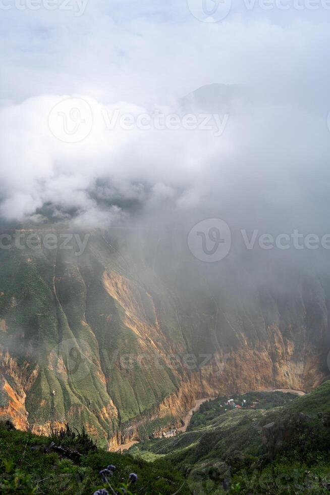 Colca Canyon and river in the mist and clouds, Peru photo