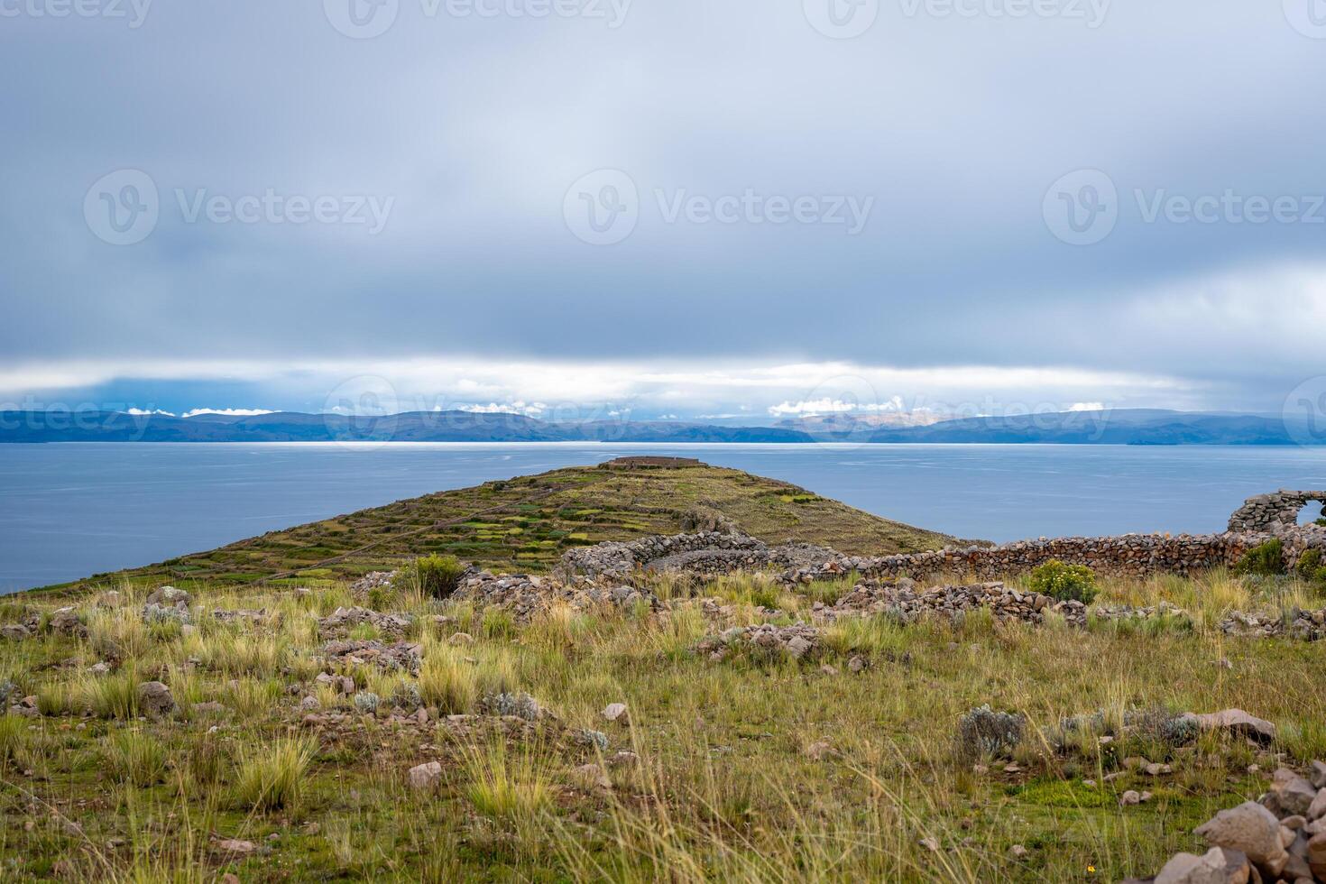 Sacred mountain of Pachatata, archaeological site on Amantani Island, Lake Titicaca, Peru photo
