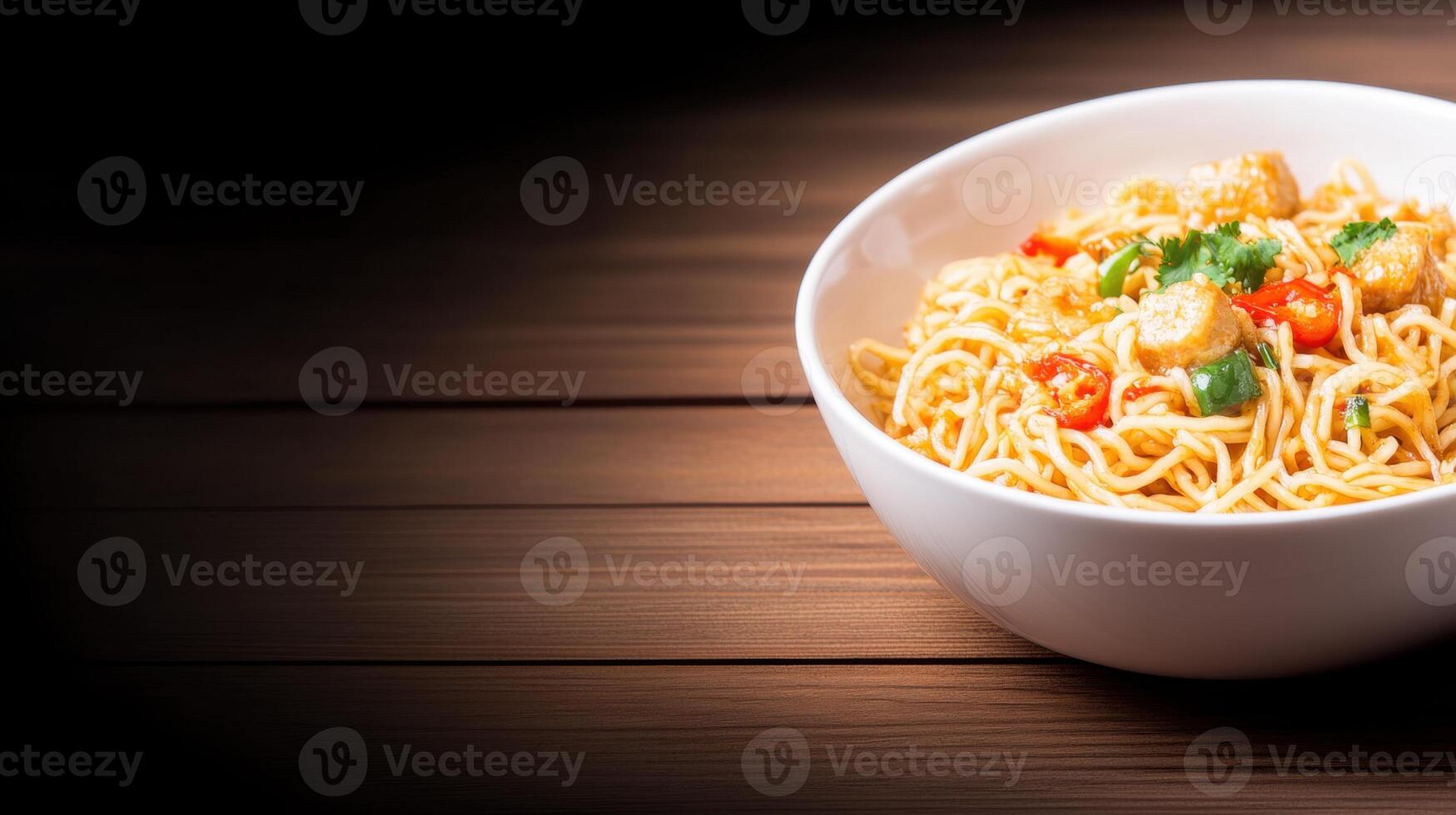 Delicious Asian noodle soup with vegetables and herbs in a white bowl on wooden table, comforting hot meal with fresh ingredients for lunch or dinner photo