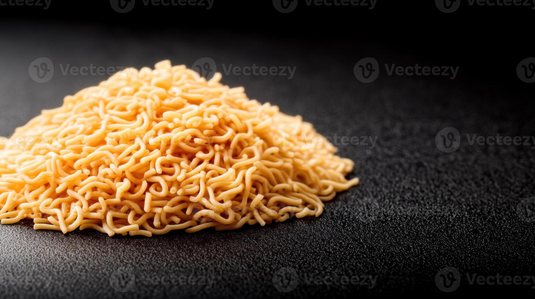 Close-up of uncooked dry instant ramen noodles on black surface with detailed texture and golden color, emphasizing food preparation and snack ingredients photo