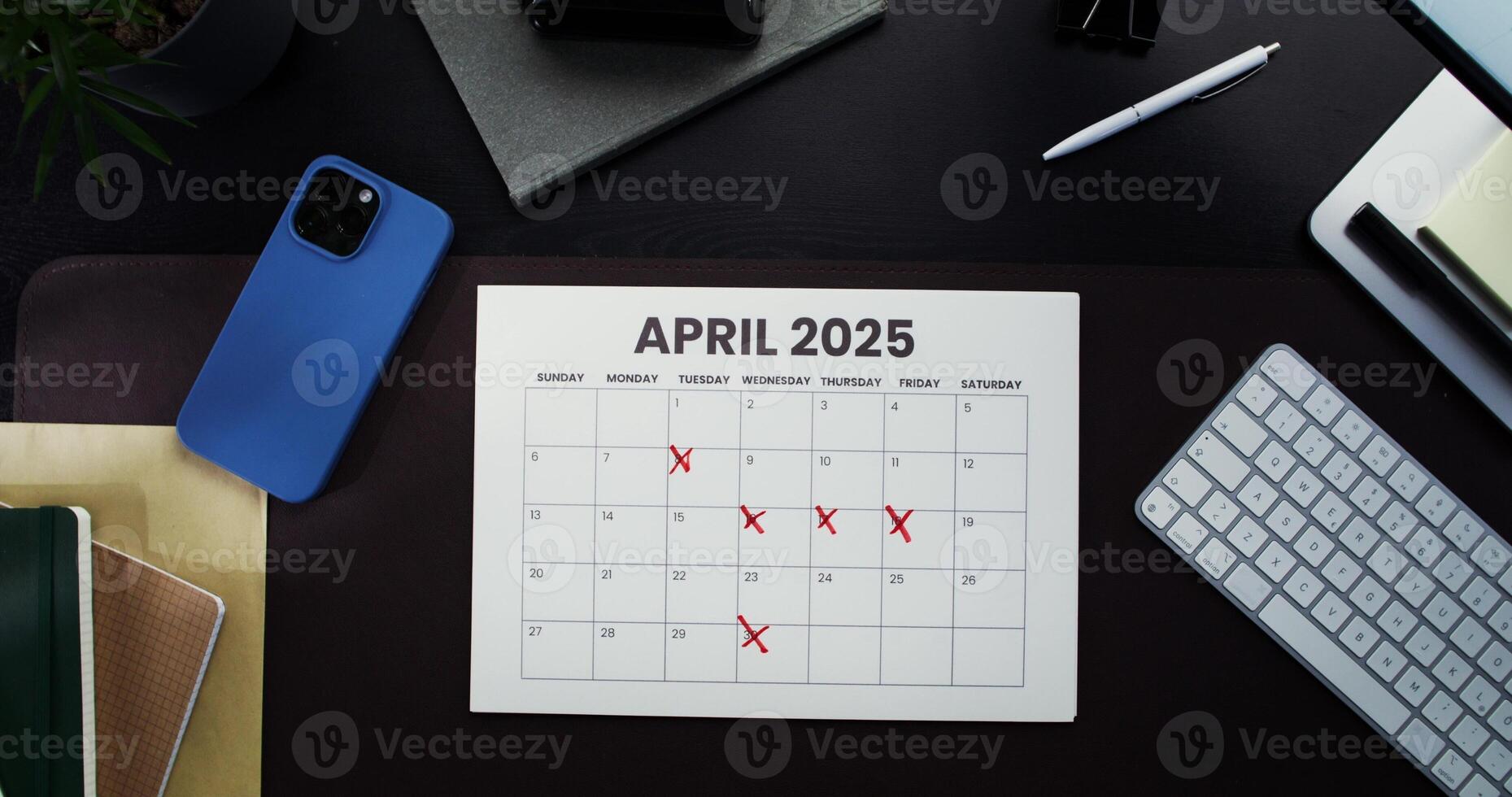 April 2025 calendar on the desk photo