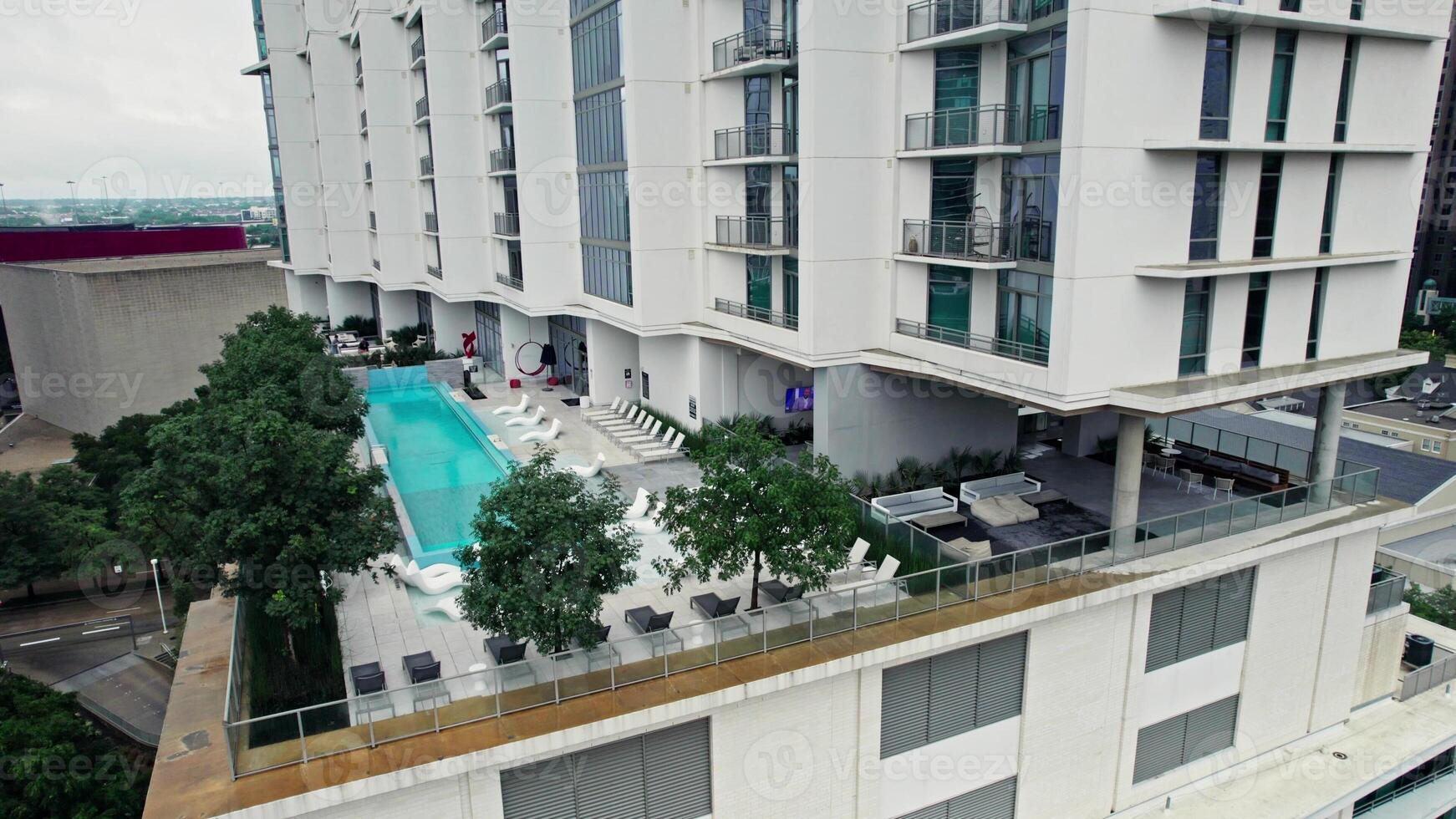 Terrace with a swimming pool on the upper floors of a skyscraper. Bird's eye view from a drone photo