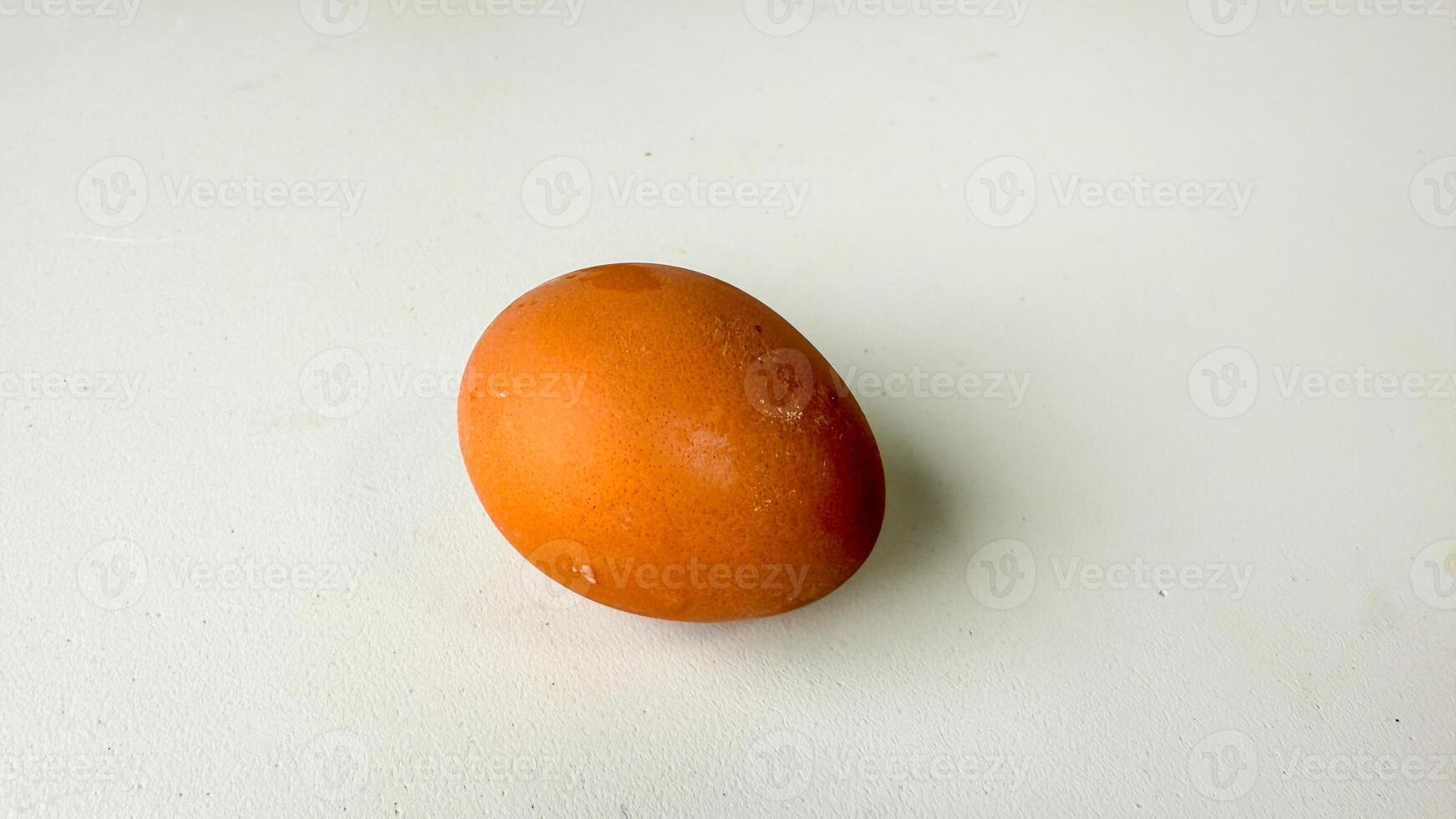 An enigmatic auburn egg on a blank canvas whispers Easters mysteries, embodying the essence of fertility and rebirth photo