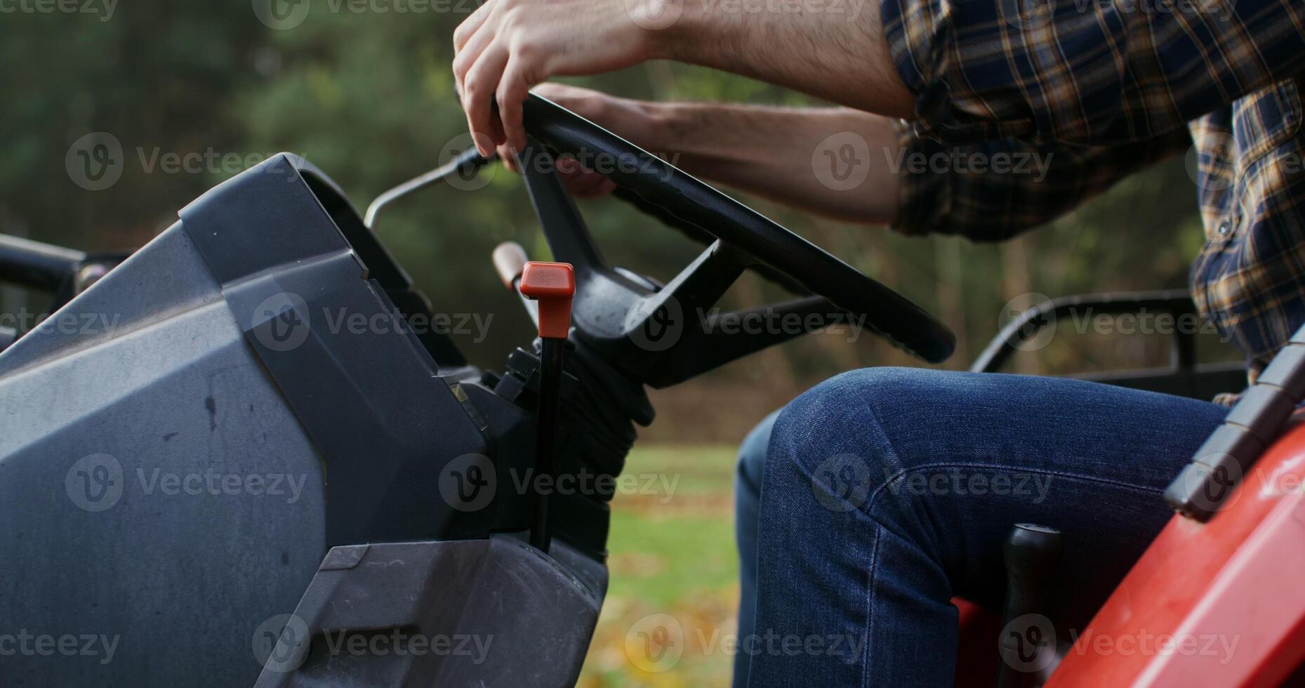 A man starts an agricultural machine and starts moving, having switched gears, a close up of male hands, no face is visible photo