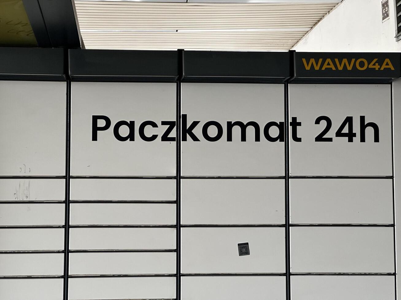 Warsaw, Poland - May 22, 2025 Paczkomat 24h automated parcel locker system in urban setting, showcasing modern delivery solutions with sleek design and functionality photo
