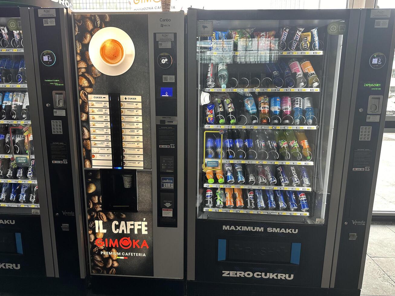 Warsaw, Poland - May 22, 2025 Vending machines displaying a variety of beverages and snacks, featuring Il Caffe Simoka coffee machine, ideal for quick refreshments in busy environments photo