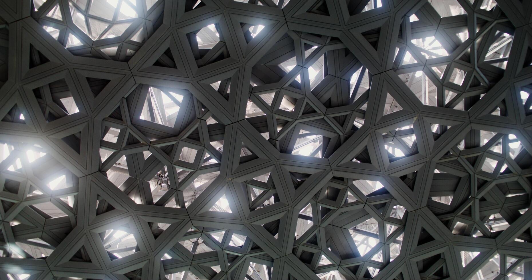 Abu Dhabi, UAE, 2025 - Close up of the openwork dome of the Louvre Dubai. The camera is spinning, the pattern resembles a kaleidoscope photo