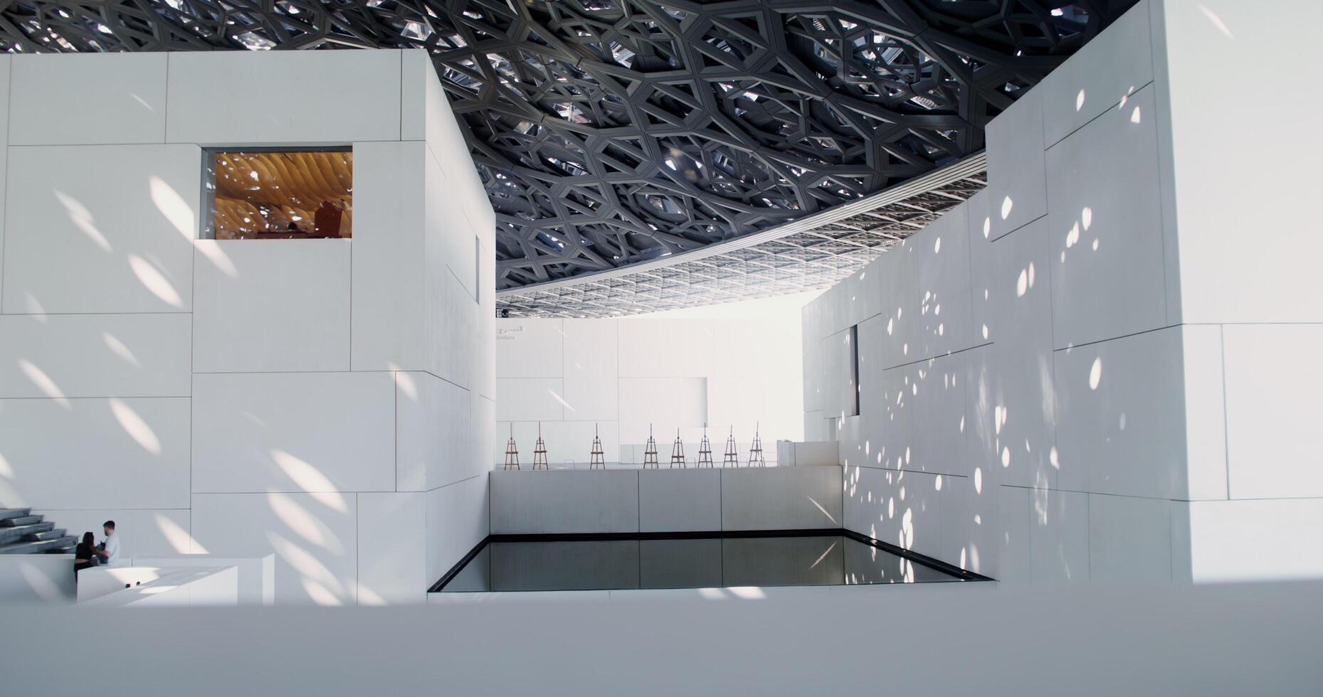 Dubai, UAE, 2025- A white minimalistic museum building with empty easels on display. Abstract structure with an openwork ceiling photo