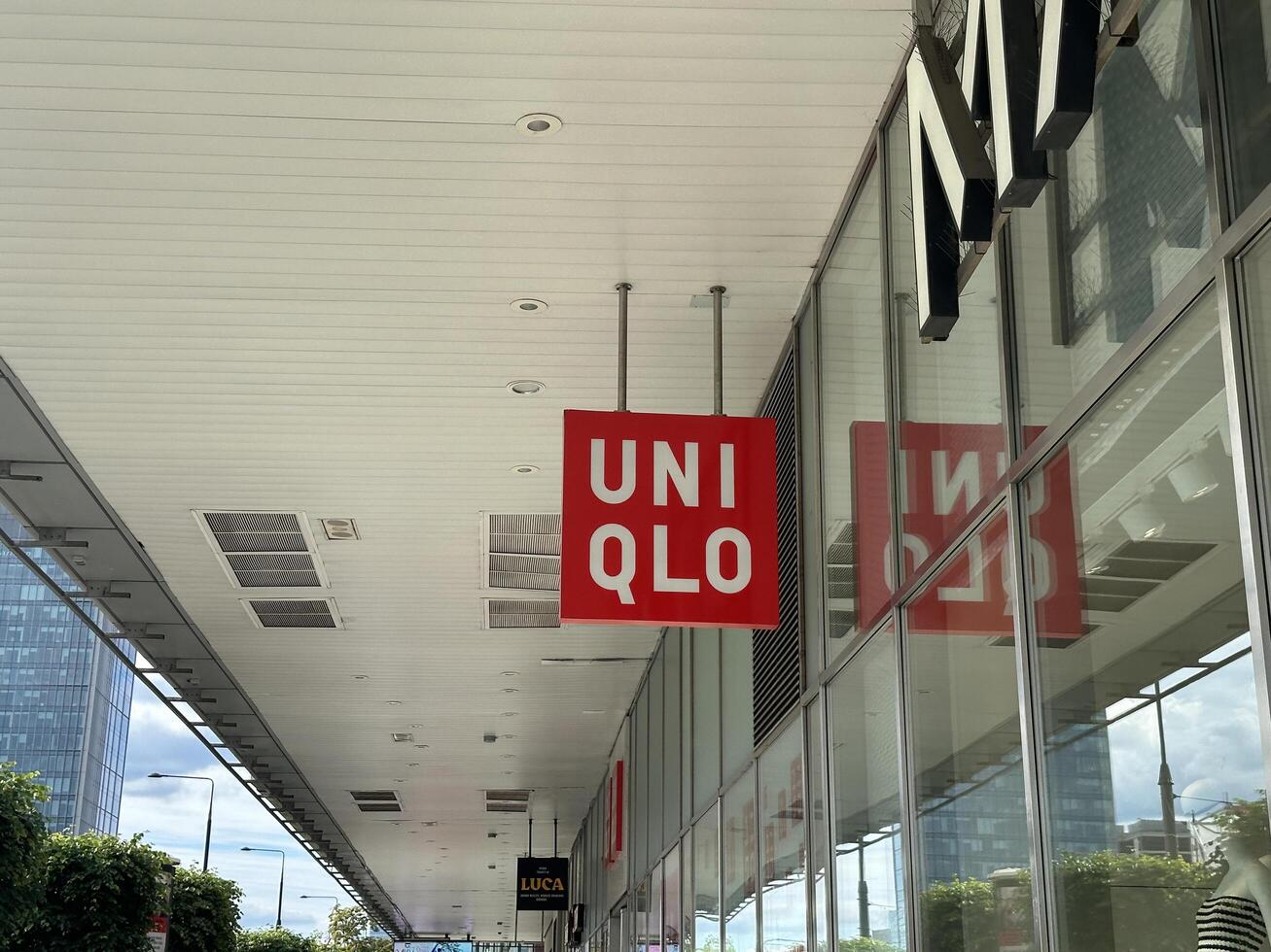 Warsaw, Poland - May 22, 2025 Uniqlo store sign prominently displayed on a modern shopping plaza, showcasing vibrant branding and inviting atmosphere for fashion enthusiasts photo