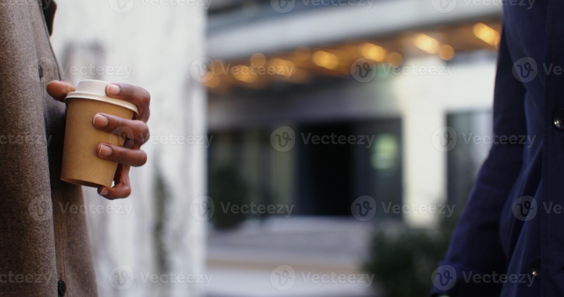 Two men of different nationalities shake hands in informal communication, standing outdoors, men's hands are close up, faces are not visible. in 4k, red komodo photo