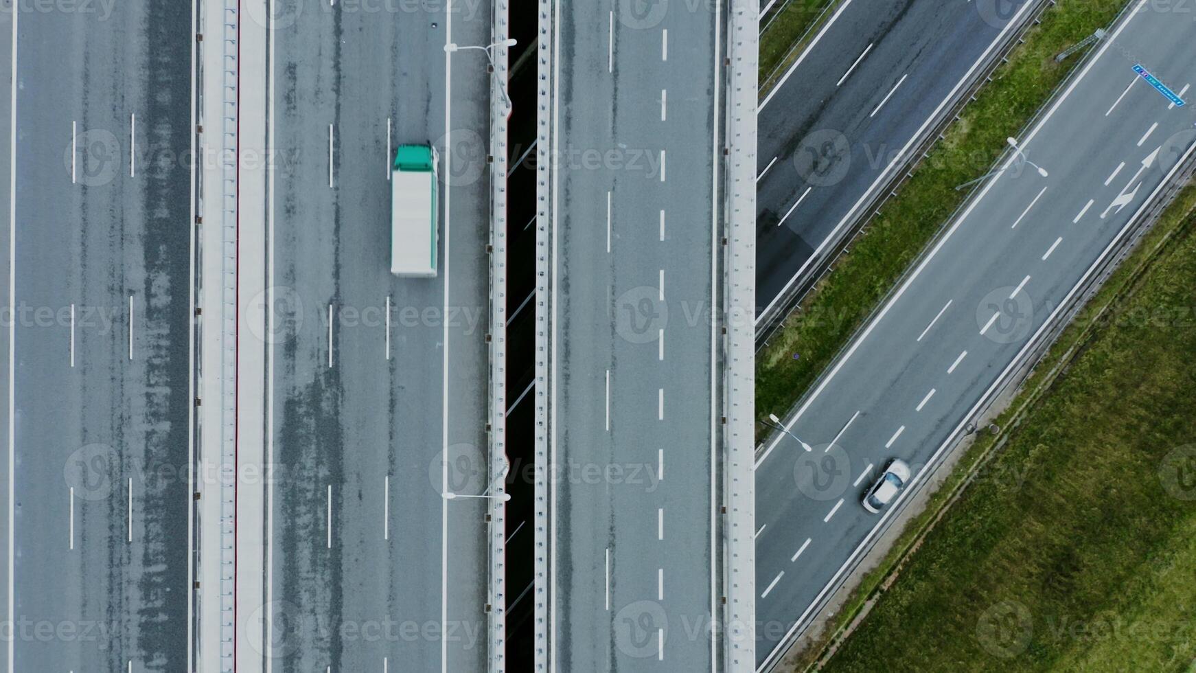 Close up of details of a road junction with passing cars, top view. Multi level road, filming from a quadrocopter. photo