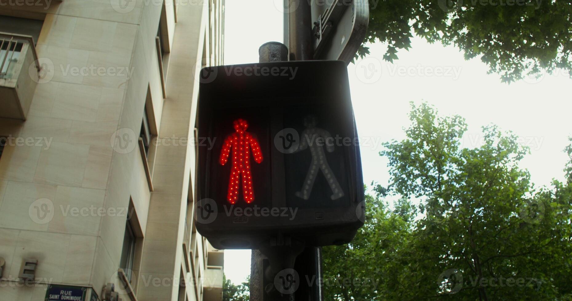 Close up of a traffic light for a pedestrian changing color from red to green. Paris, France. 4k , red komodo photo