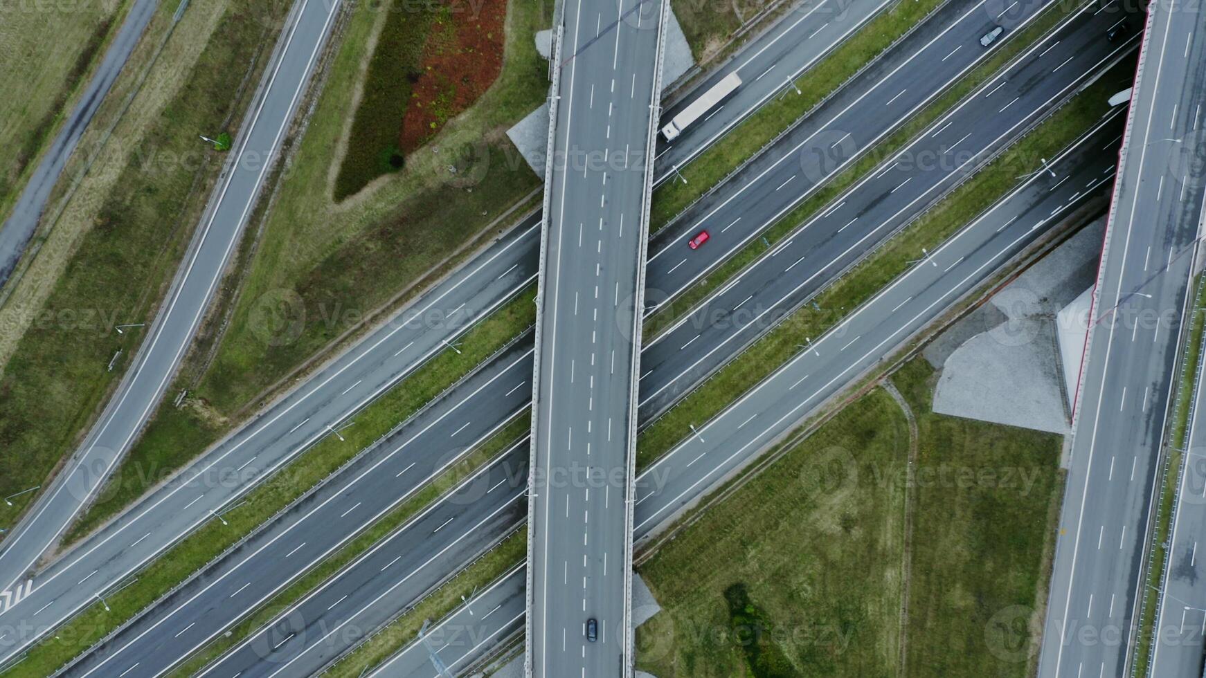 View of the road junction with cars passing along it, shooting from a drone. Multi level road, top view, filming from a quadrocopter. photo