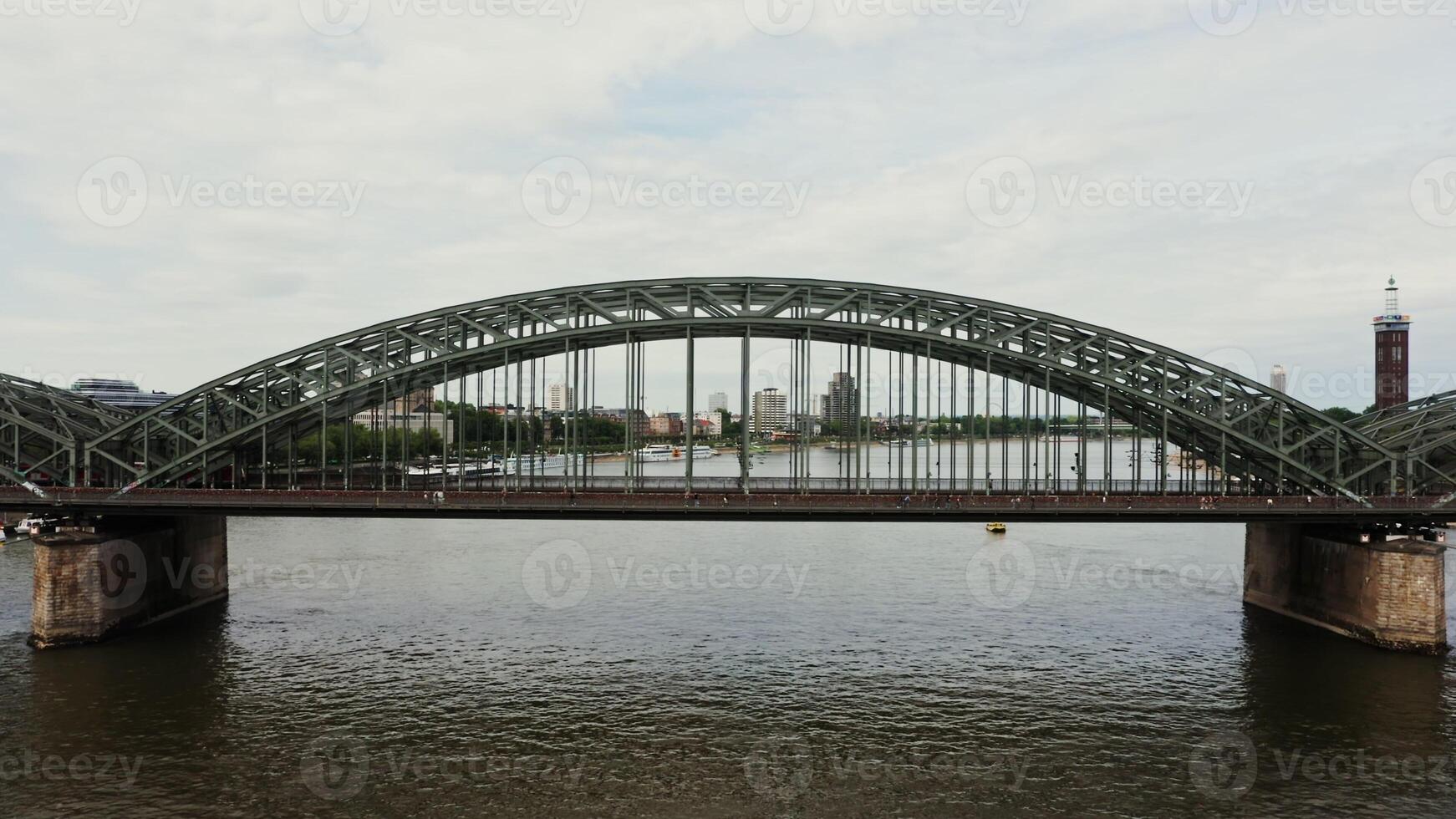 Drone , view of the railway pedestrian bridge in the city of Cologne. A bridge with metal semicircles rising above the road, aerial view from the river. photo