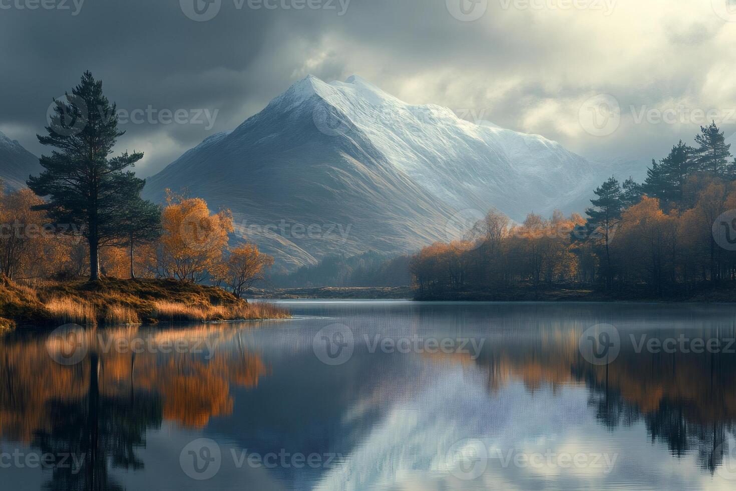 Beautiful mountain reflecting in a calm lake with autumn trees and a cloudy sky photo