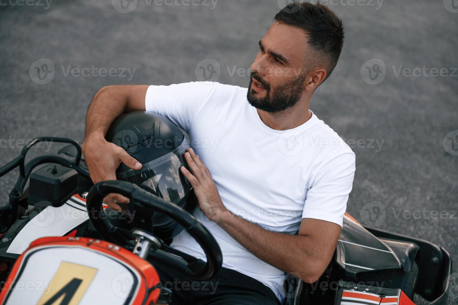 Handsome positive ,,man ,is ,outdoors, kart racing conception photo