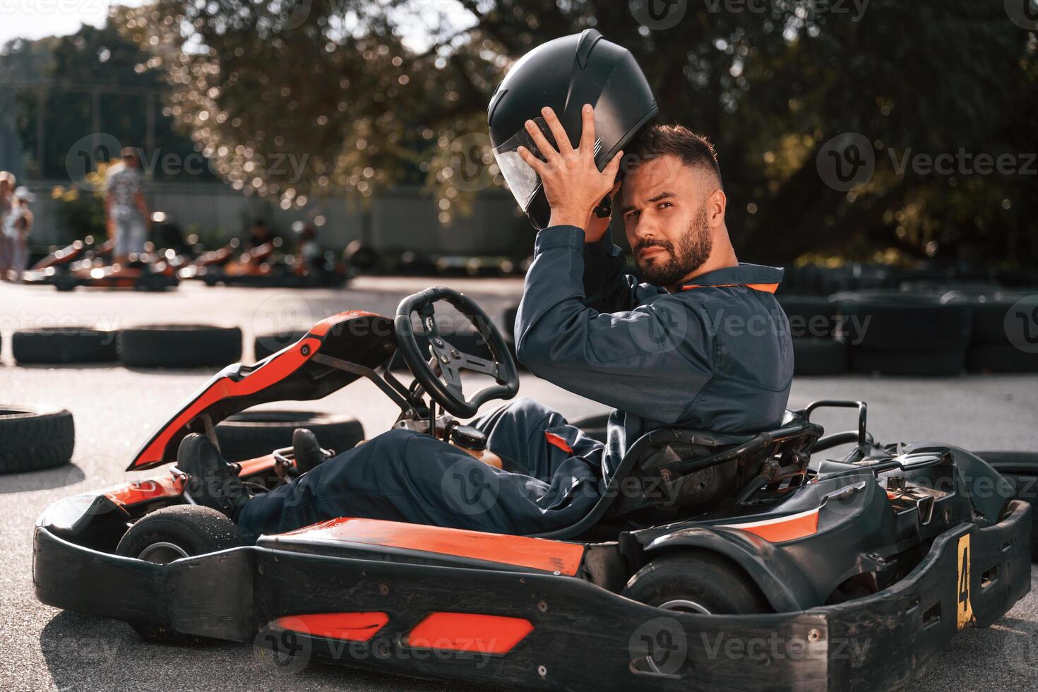 Wearing the safety helmet. Man is outdoors, kart racing conception photo