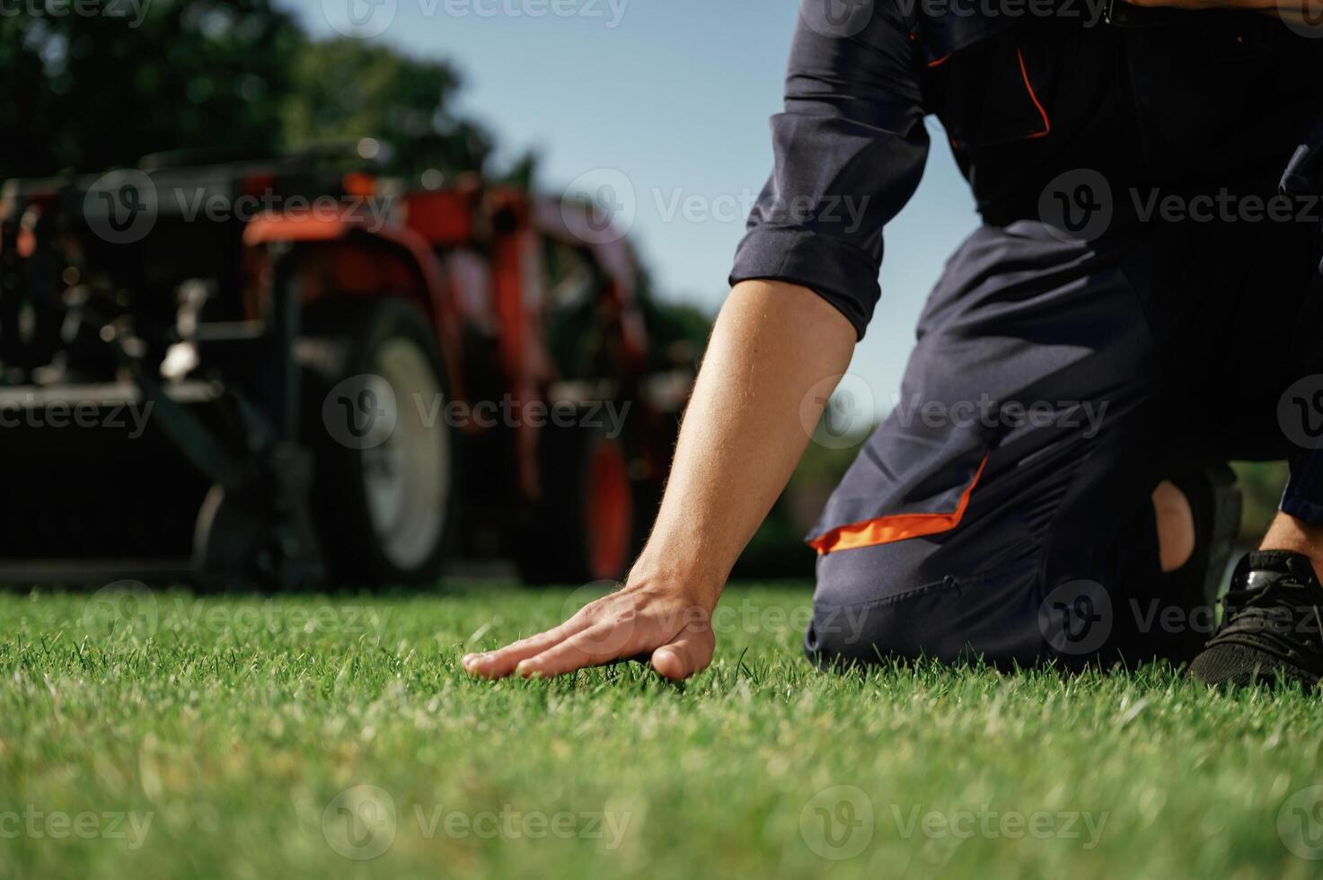 Quality control, touching,, the, grass. Man is with utility tractor with grass cutter and aerator equipment on the field photo