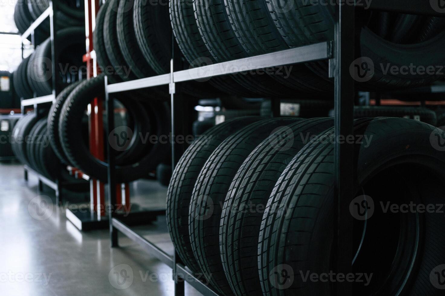 New tires are placed on, the ,storage, rack i,n the car workshop photo