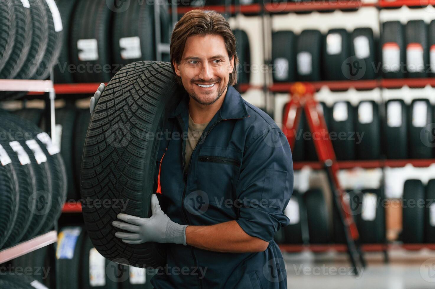 Cheerful, smiling...., Man is in the tire fitting car service photo