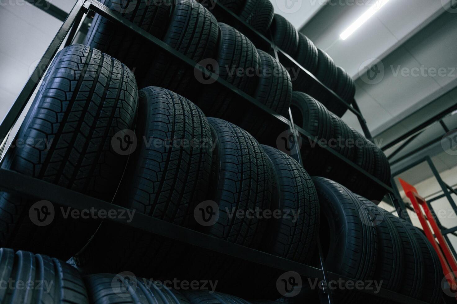 On the shelves. New tires are placed on the storage rack in the car workshop photo