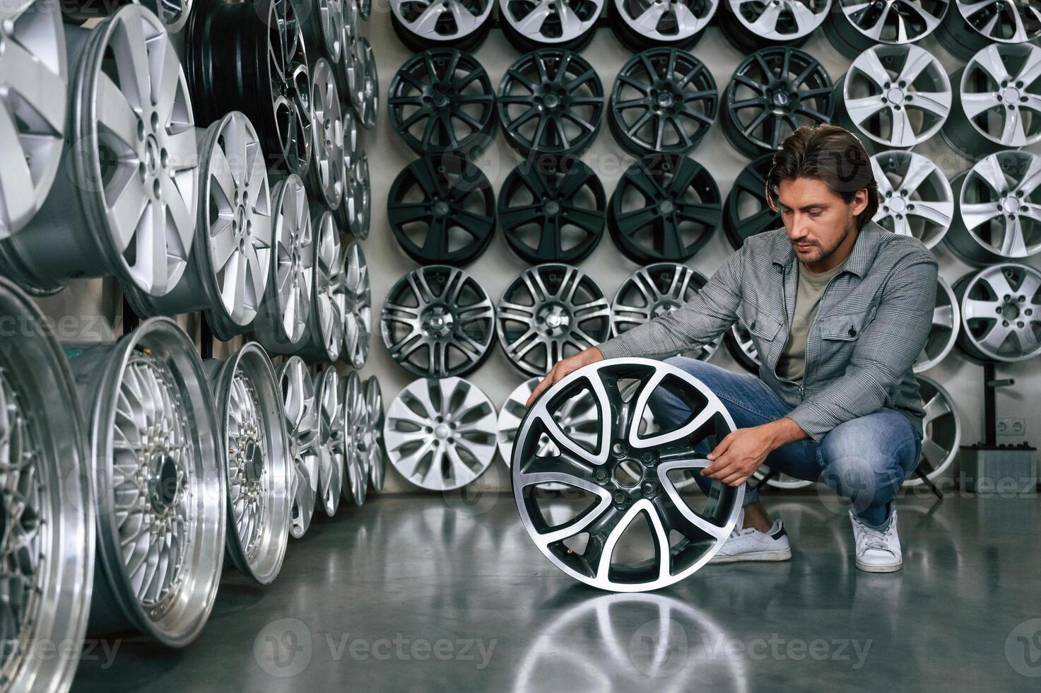 Big, choice.... Man is in the tire fitting car service photo