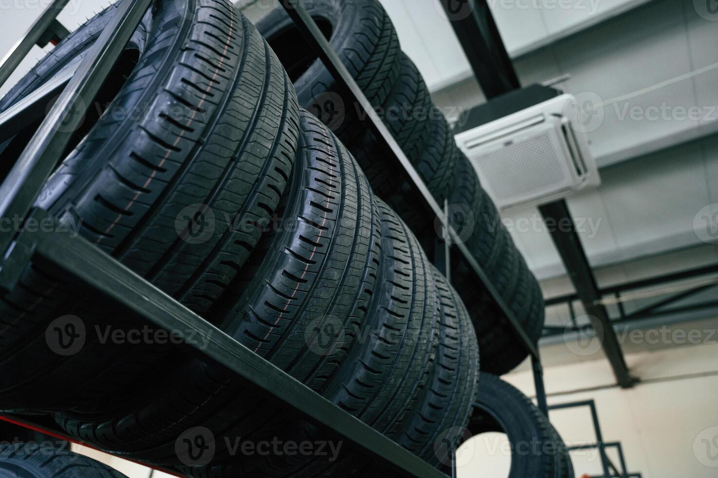 On the shelves. New tires, are placed on the storage rack in the car workshop photo