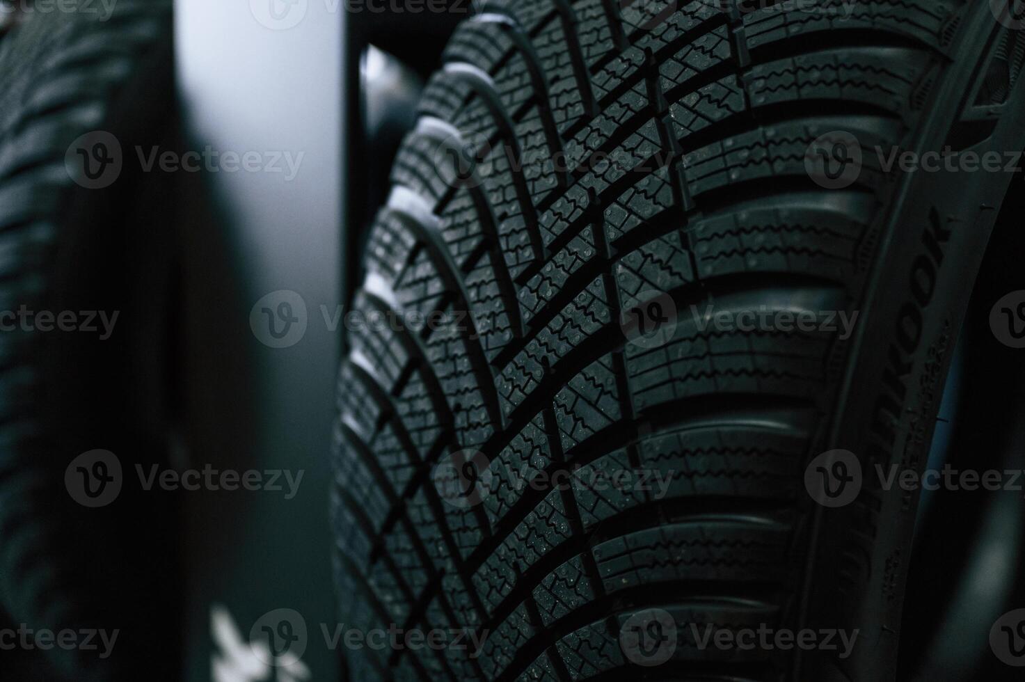 Particle close up view. New tires,, are placed on the storage rack in the car workshop photo