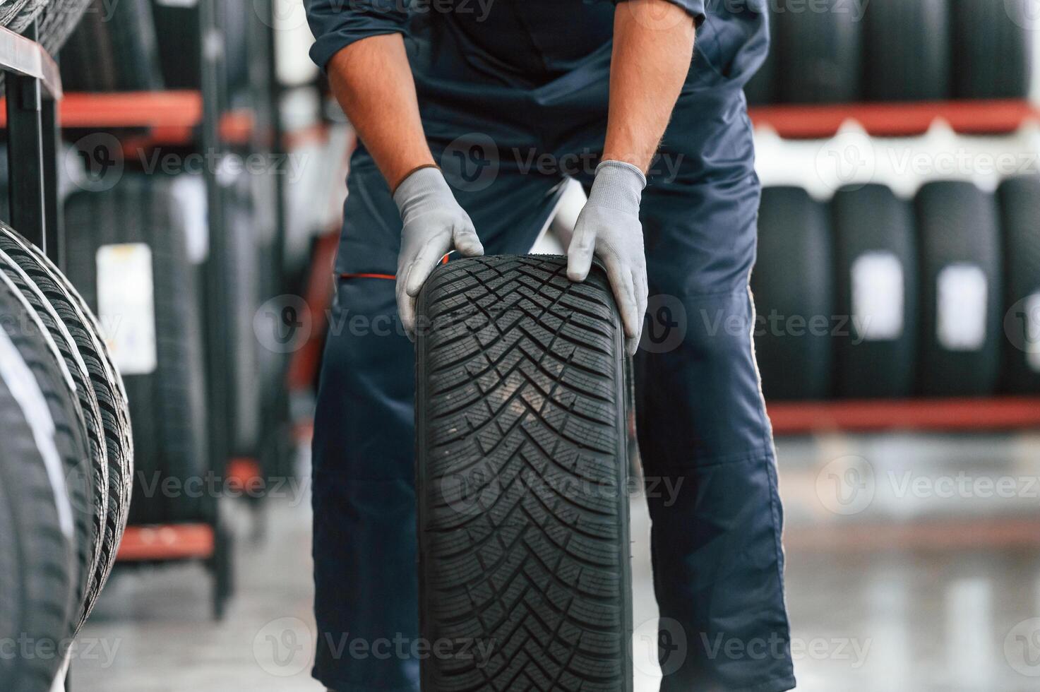 Detailed close, up, view, moving the wheel. Man is in the tire fitting car service photo