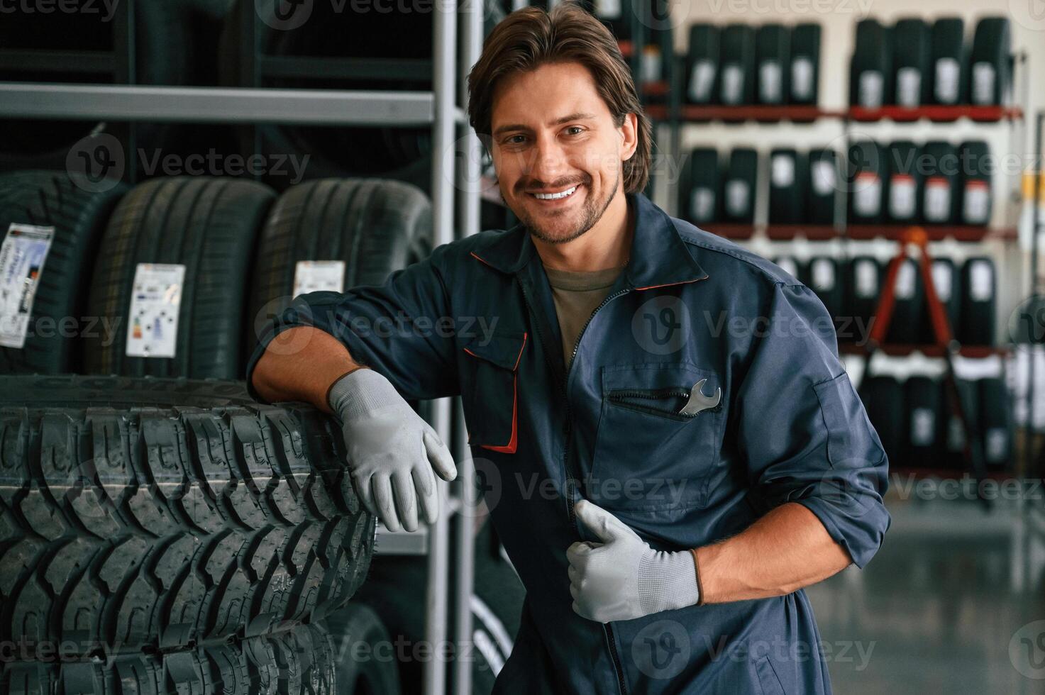 Positive ,facial expression. Man ,is in the tire fitting car service photo
