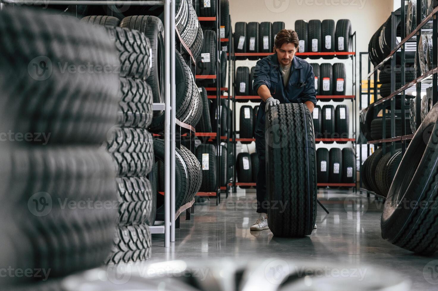 Rolling ,the, wheel. Man is in the tire fitting car service photo