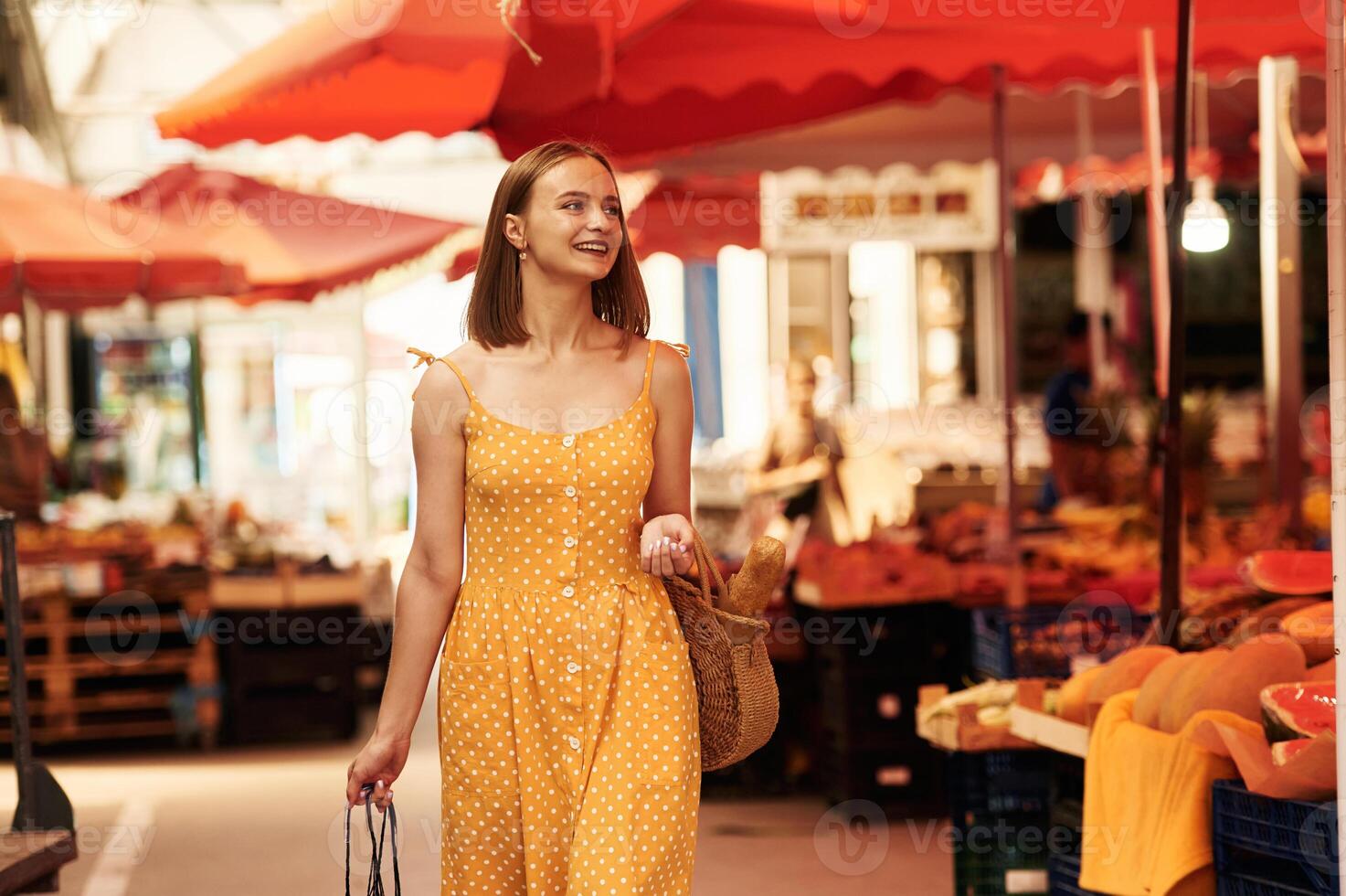 Walking around. ..Young woman is on the vegetable market or bazaar,,. photo